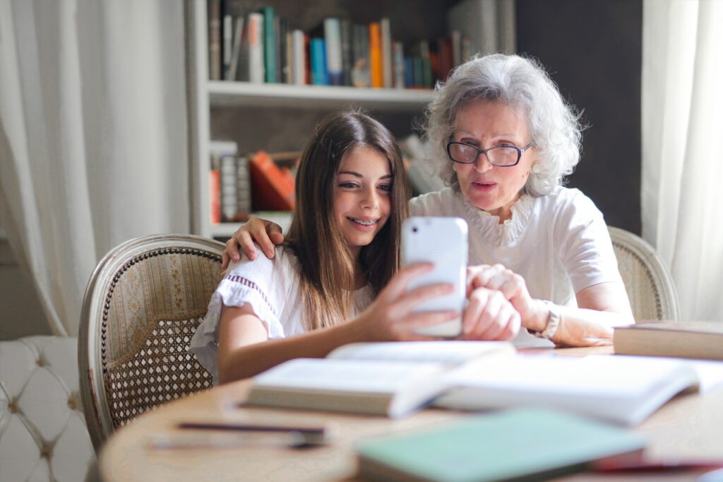 Older woman and granddaughter taking a selfie together