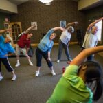 Residents stretching during senior living activities